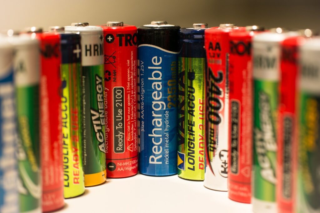 Picture of different batteries with reusable battery in the middle | Disposable vs Rechargeable batteries