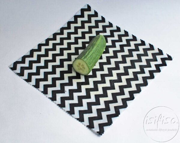 Black chevron beeswax wrap displayed with cucumber (food)