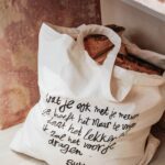 reusable cloth bag in cream with bread inside planet friendly bag
