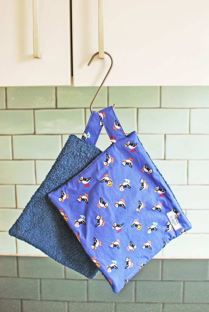 Home wipes with puffins on blue background with a hang tag
