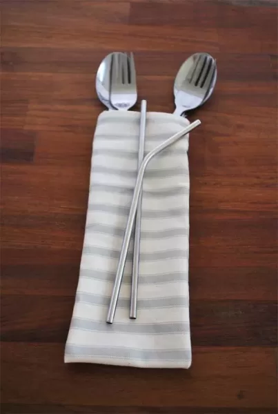 cutlery pouch with dinnerware on wood background eco friendly products from isifiso