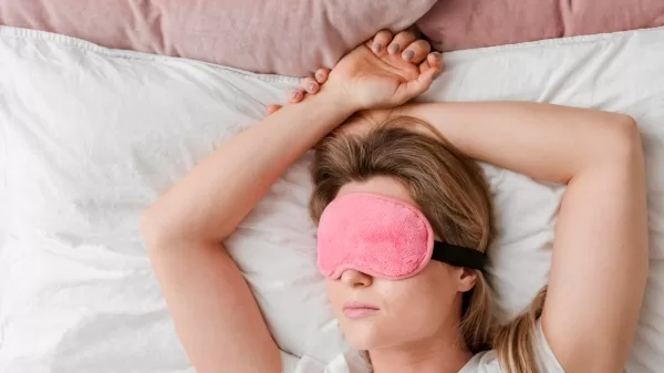 woman in bed - weighted eye mask benefits